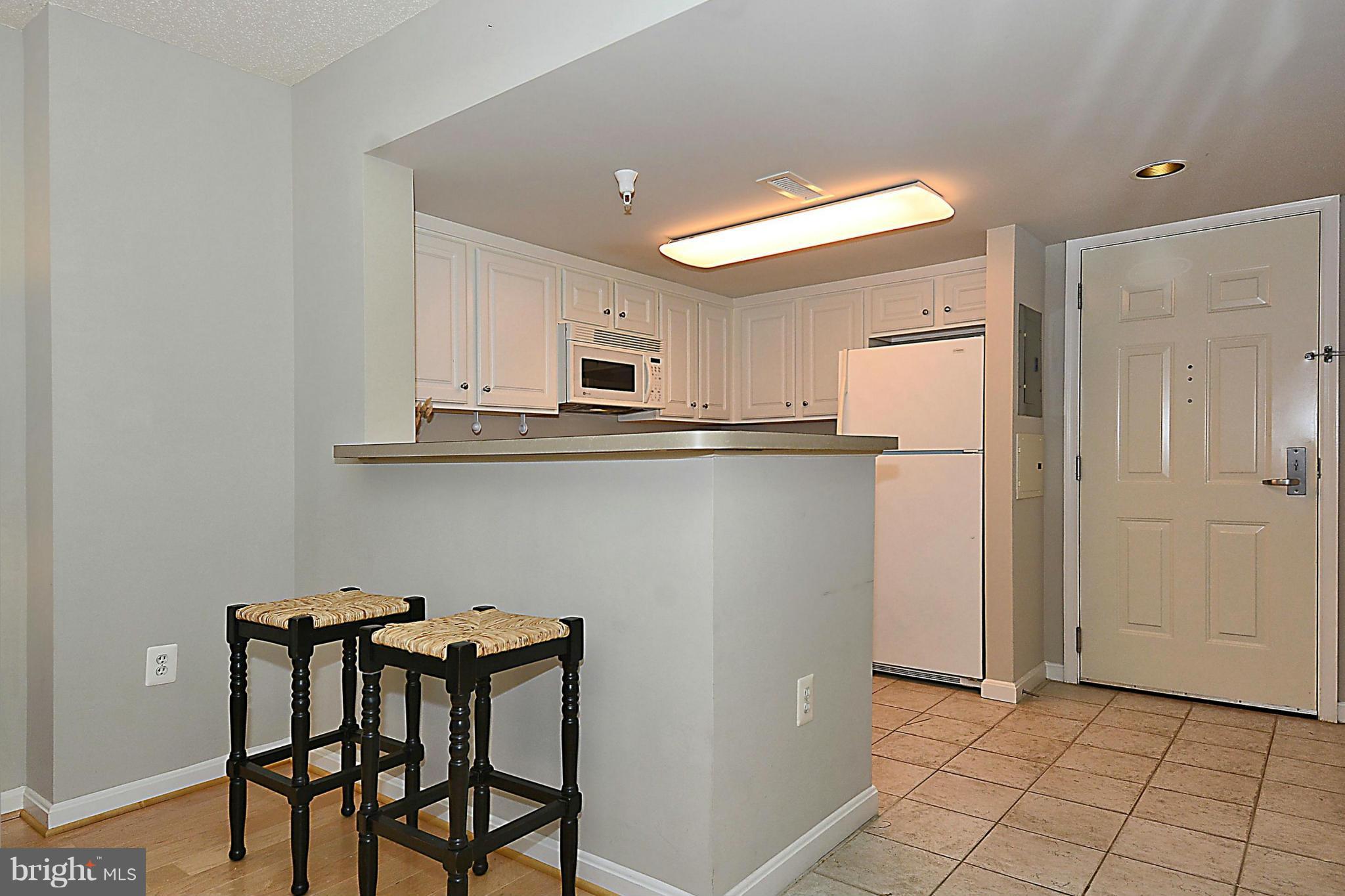 11710 Old Georgetown Road, Unit 419 North Bethesda, MD 20852 - Photo 9 of 30 a kitchen with stainless steel appliances a refrigerator and microwave