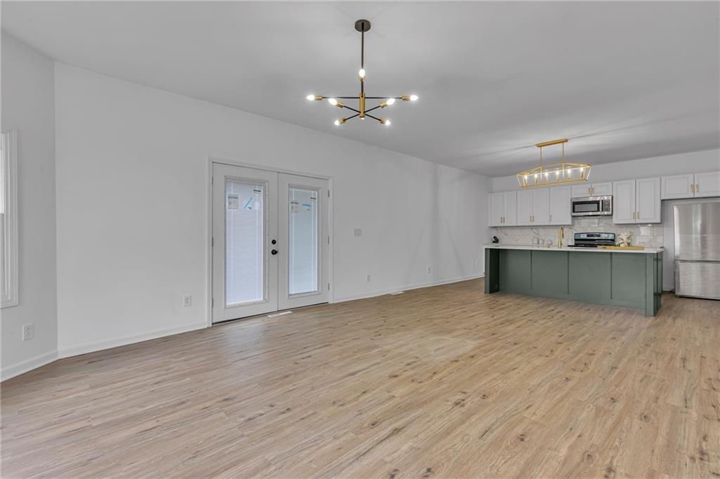193 Virginia Avenue Rochester, PA 15074 - Photo 10 of 37 a view of a kitchen with a stove cabinets and wooden floor
