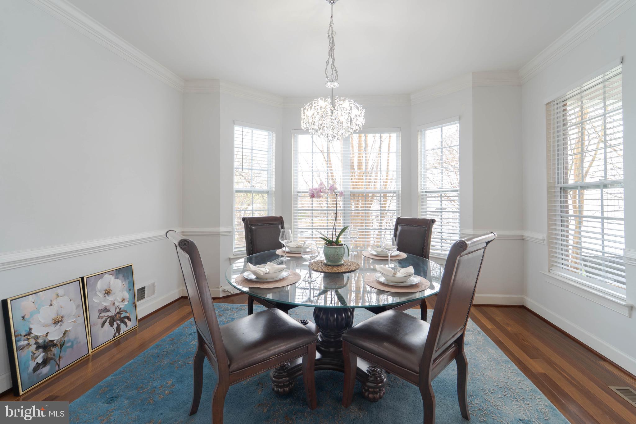 16309 Sandy Ridge Court Woodbridge, VA 22191 - Photo 15 of 93 a view of a dining room with furniture a chandelier and wooden floor
