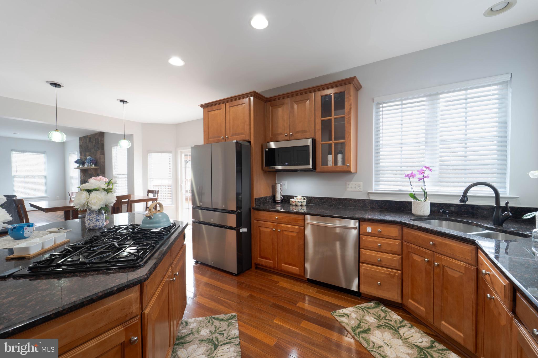 16309 Sandy Ridge Court Woodbridge, VA 22191 - Photo 18 of 93 a kitchen with stainless steel appliances granite countertop a stove refrigerator sink and cabinets