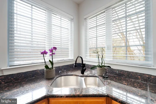 a white bath tub sitting in a bathroom next to a window