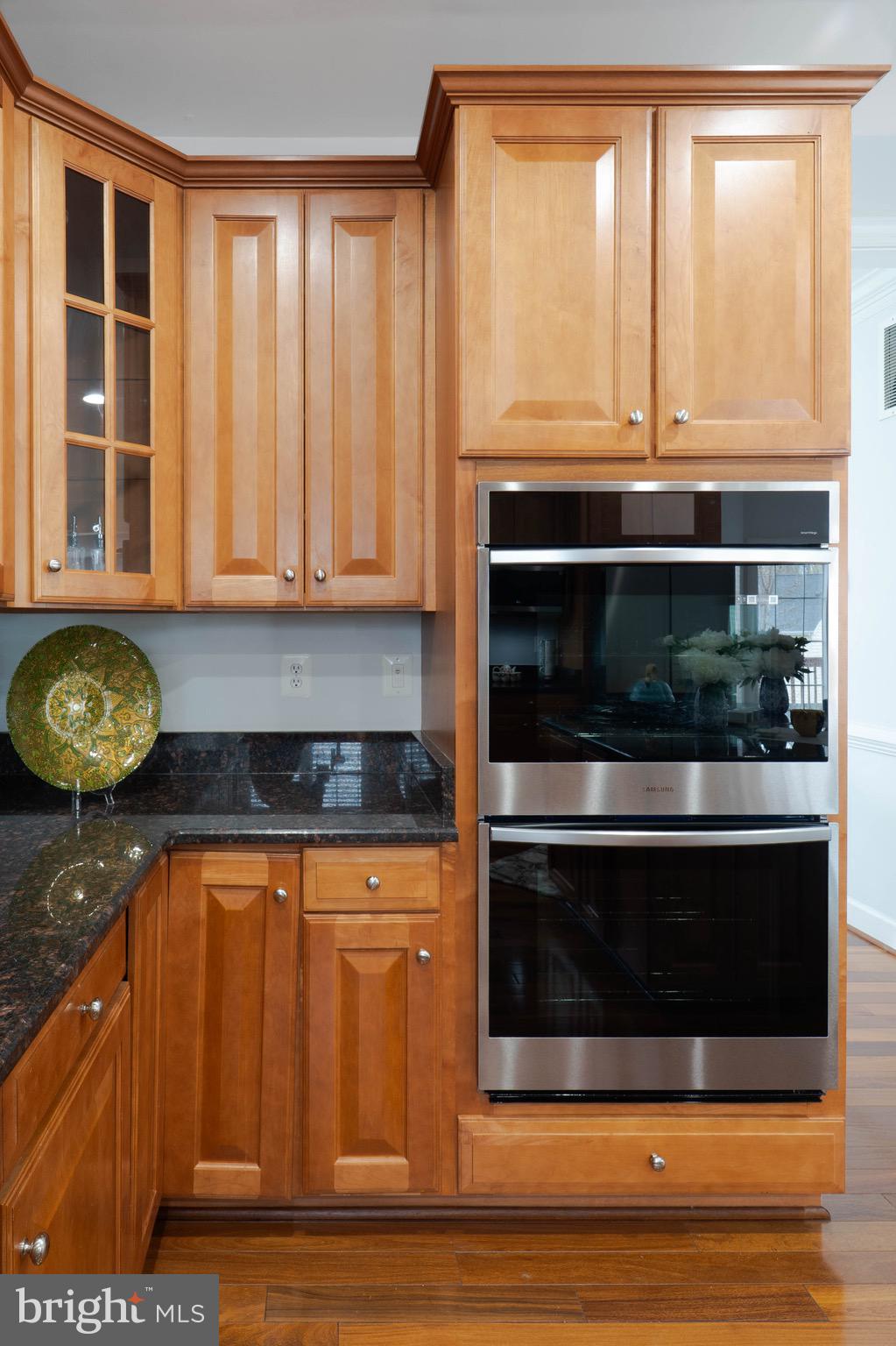 16309 Sandy Ridge Court Woodbridge, VA 22191 - Photo 24 of 93 a kitchen with granite countertop a stove and a white cabinet