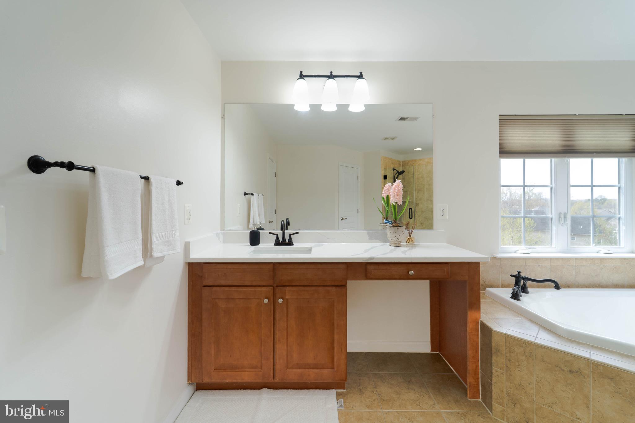16309 Sandy Ridge Court Woodbridge, VA 22191 - Photo 48 of 93 a spacious bathroom with a sink double vanity and a large mirror