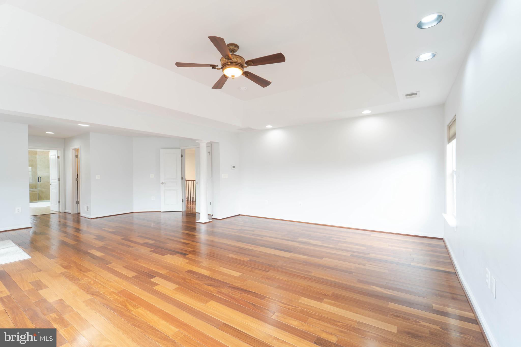 16309 Sandy Ridge Court Woodbridge, VA 22191 - Photo 53 of 93 a view of an empty room with wooden floor and a ceiling fan