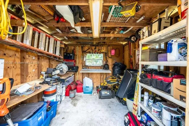 a view of a house with a yard and potted plants