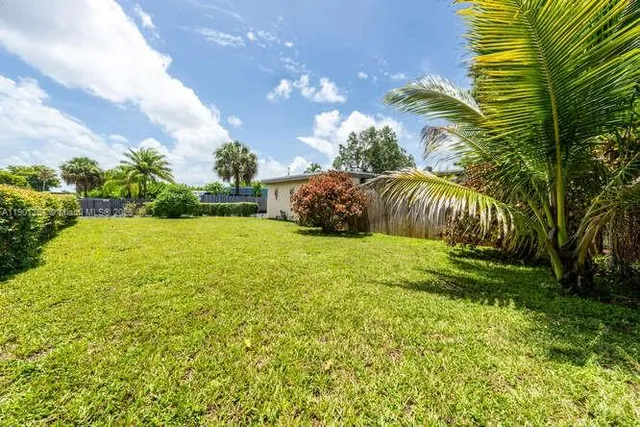 a view of yard with green space and seating area