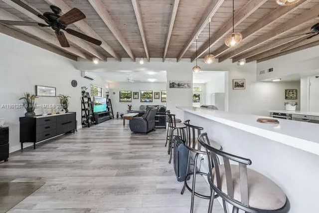 a living room with lots of furniture and a wooden floor