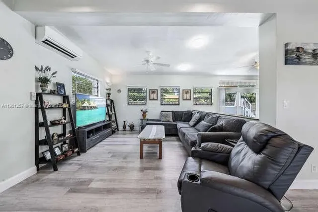 a living room with furniture and a flat screen tv