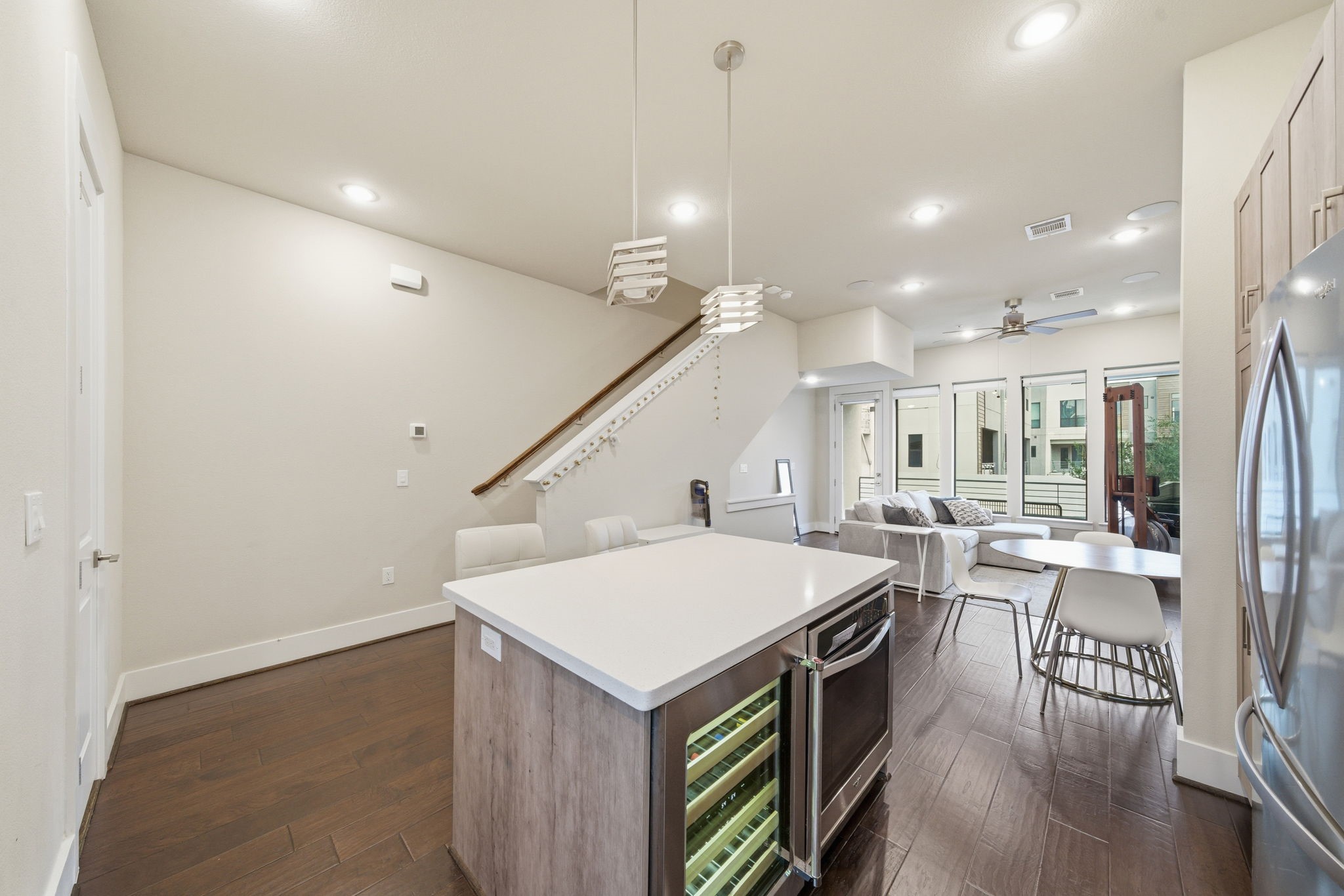 2401 Crawford Street, Unit C1C Houston, TX 77004 - Photo 11 of 24 a kitchen with a stove a refrigerator and a dining table with wooden floor
