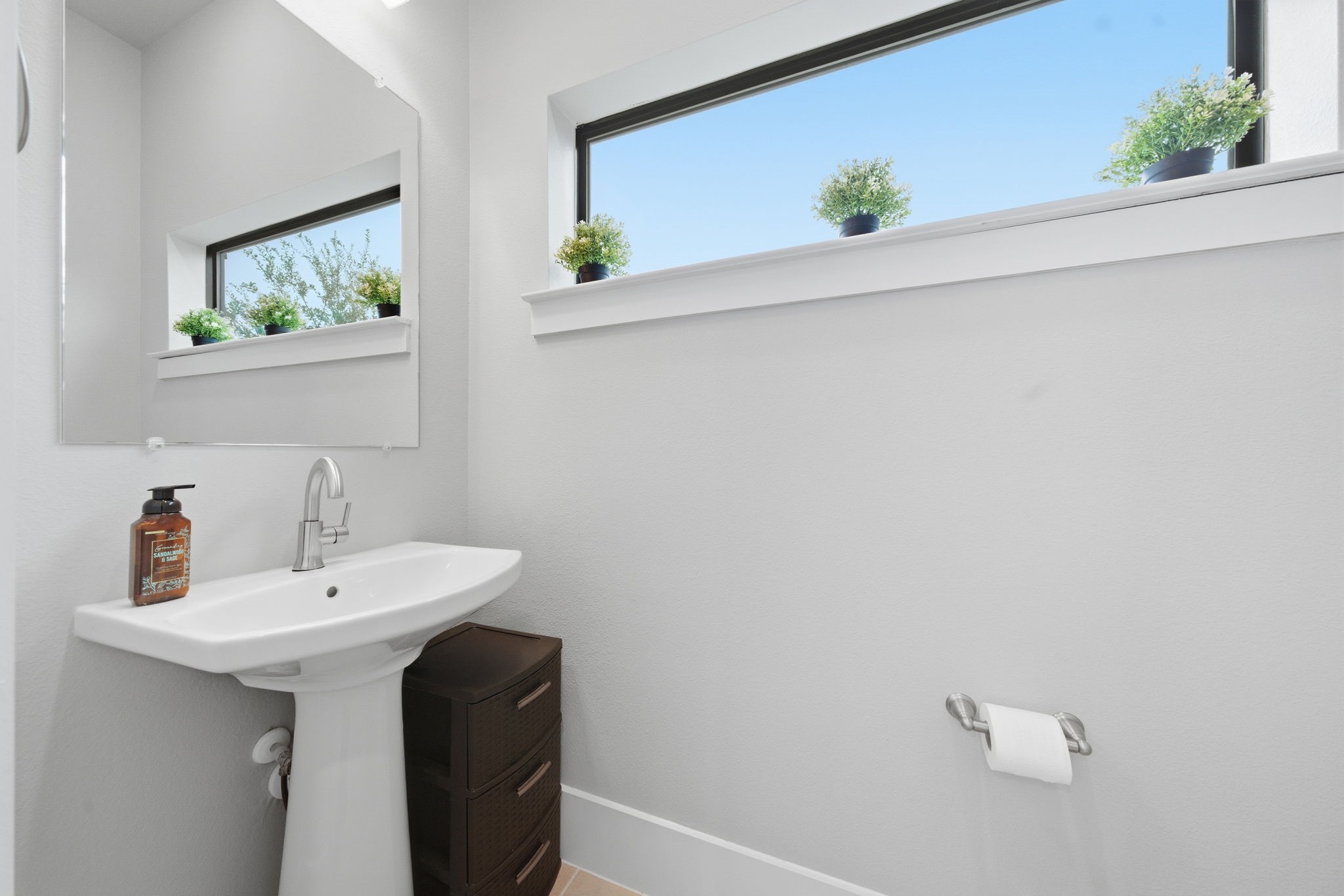 2401 Crawford Street, Unit C1C Houston, TX 77004 - Photo 13 of 24 a bathroom with a sink and a mirror