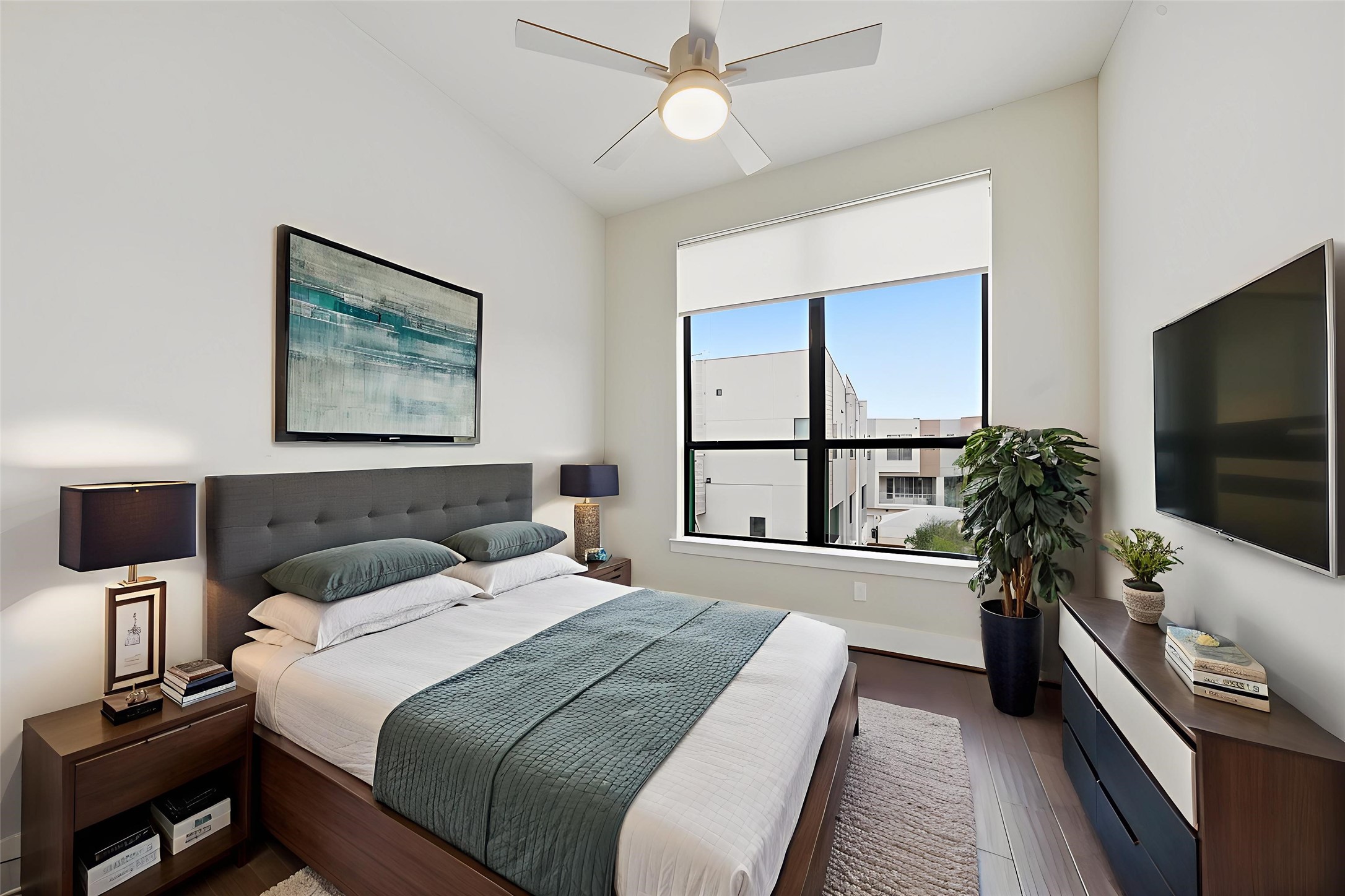 2401 Crawford Street, Unit C1C Houston, TX 77004 - Photo 15 of 24 a bedroom with a large bed and a flat screen tv