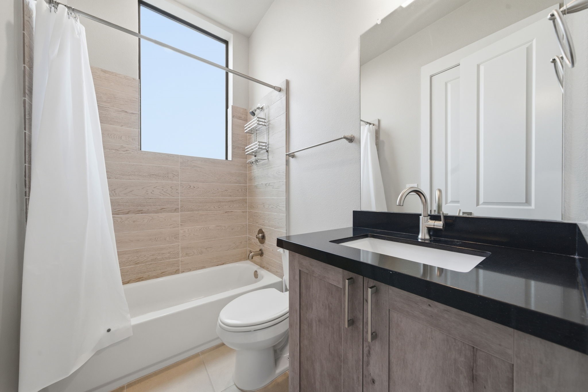 2401 Crawford Street, Unit C1C Houston, TX 77004 - Photo 16 of 24 a bathroom with a granite countertop sink toilet and shower
