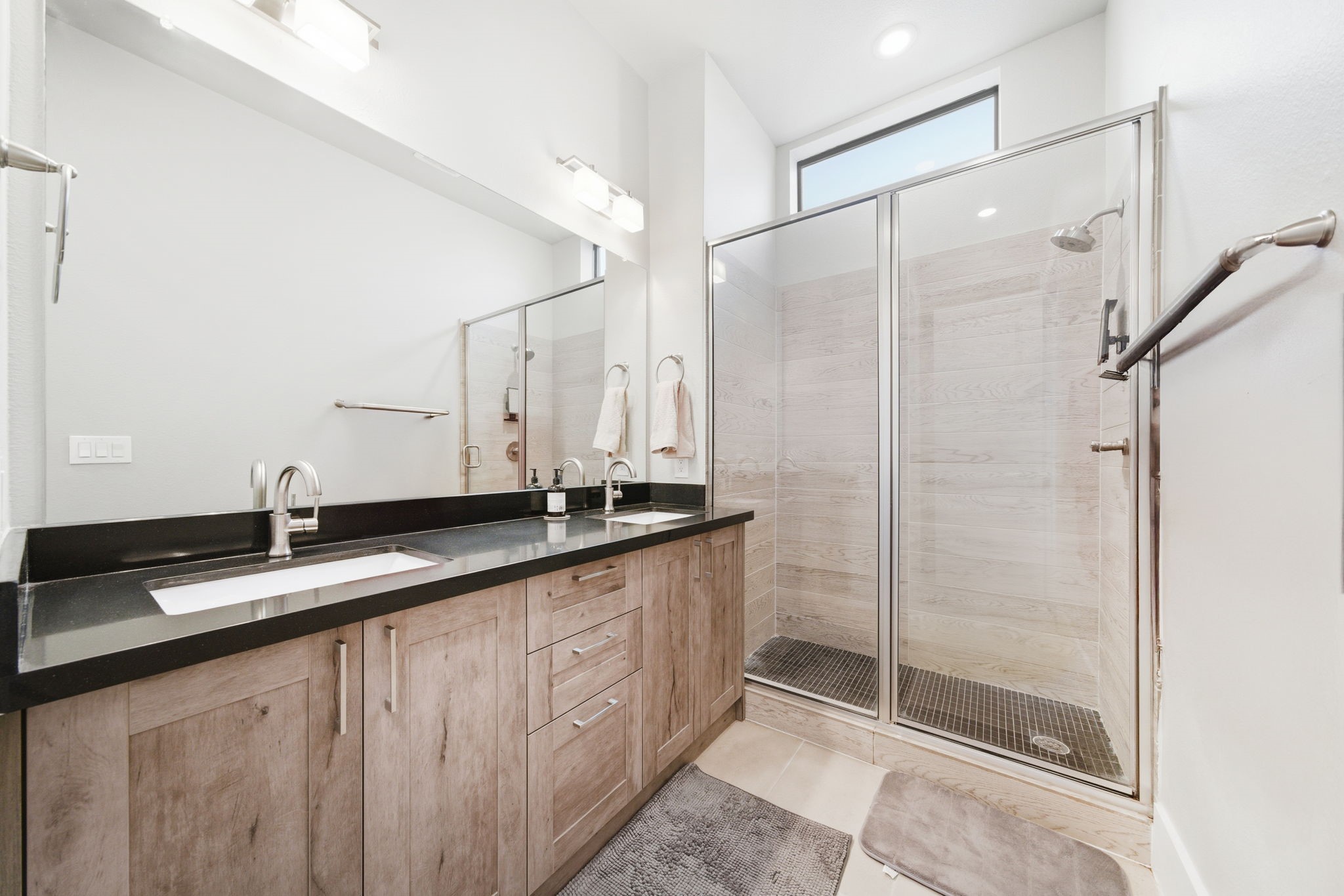 2401 Crawford Street, Unit C1C Houston, TX 77004 - Photo 18 of 24 a bathroom with a granite countertop sink a mirror and a shower