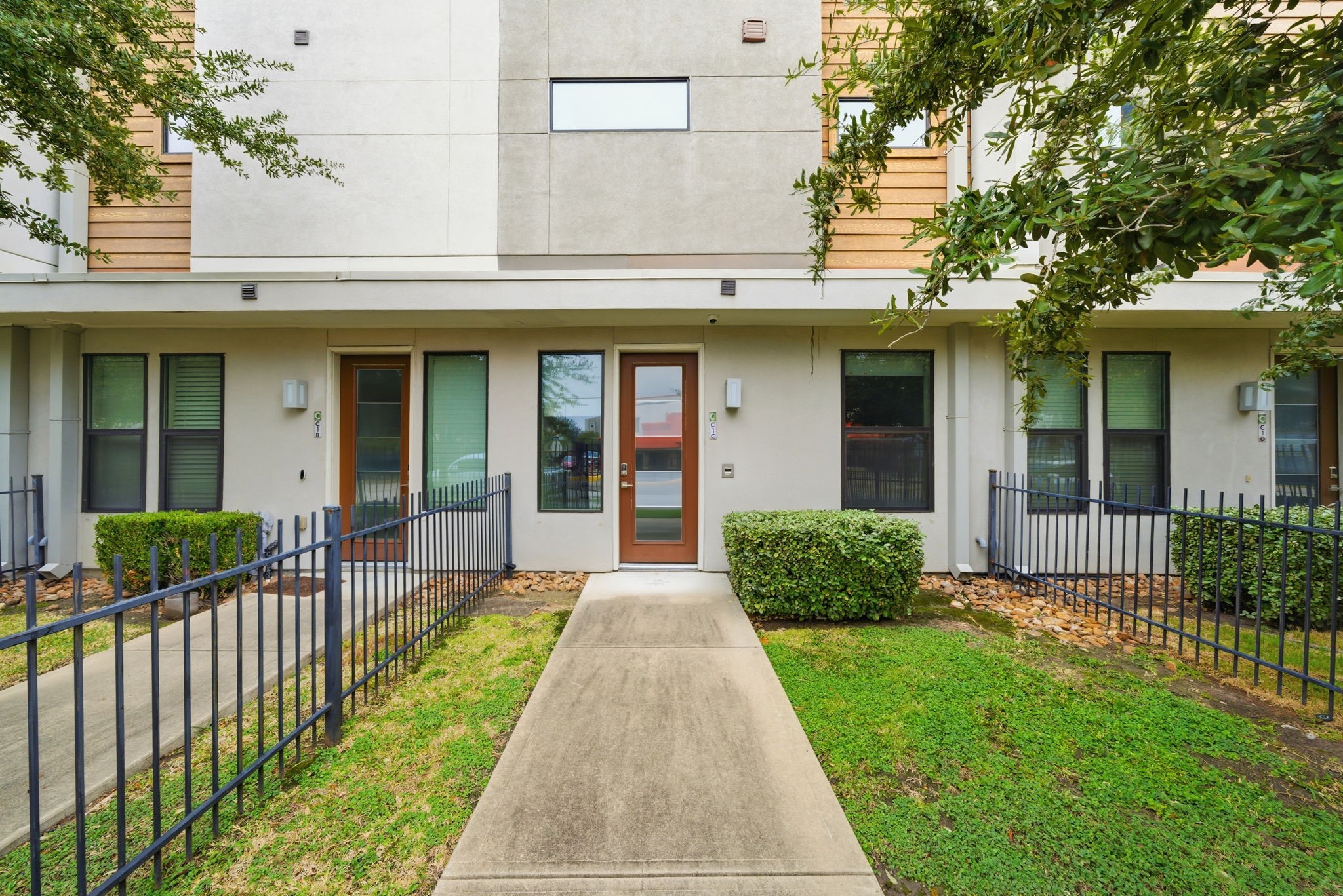 2401 Crawford Street, Unit C1C Houston, TX 77004 - Photo 2 of 24 a front view of a house with a yard and porch