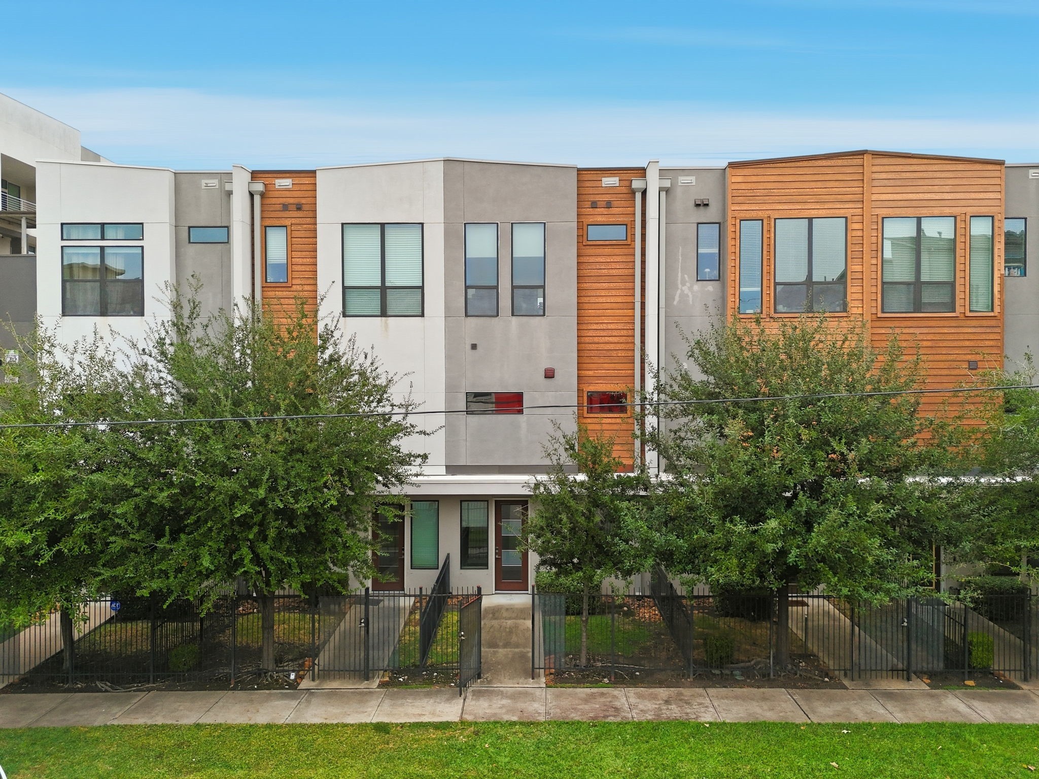 2401 Crawford Street, Unit C1C Houston, TX 77004 - Photo 21 of 24 a front view of residential houses with yard and trees