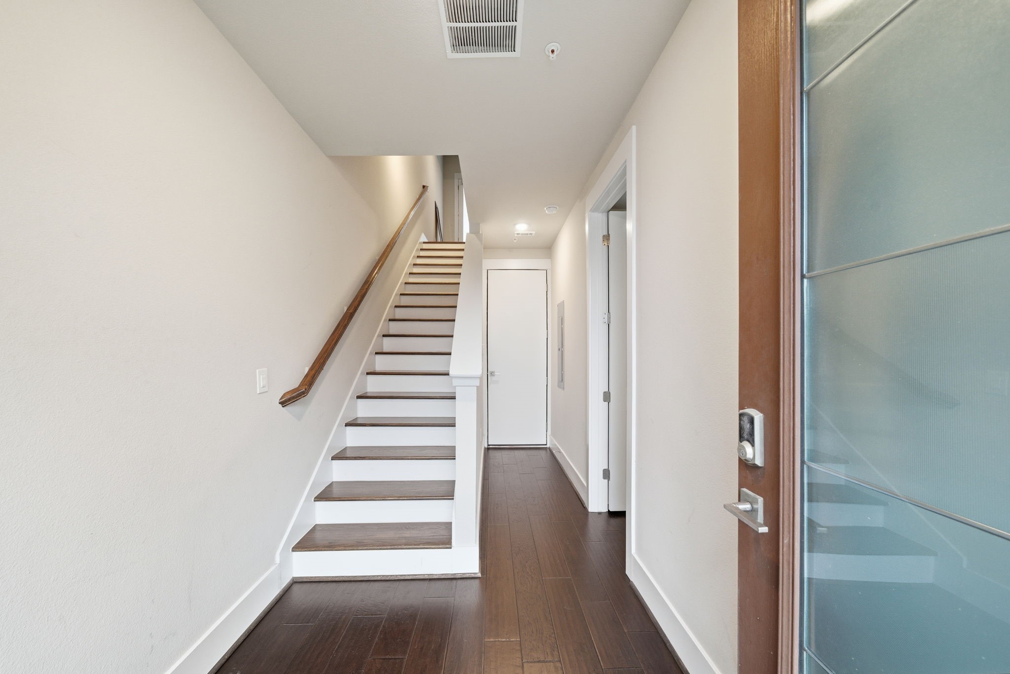 2401 Crawford Street, Unit C1C Houston, TX 77004 - Photo 3 of 24 a view of a hallway with wooden floor and entryway