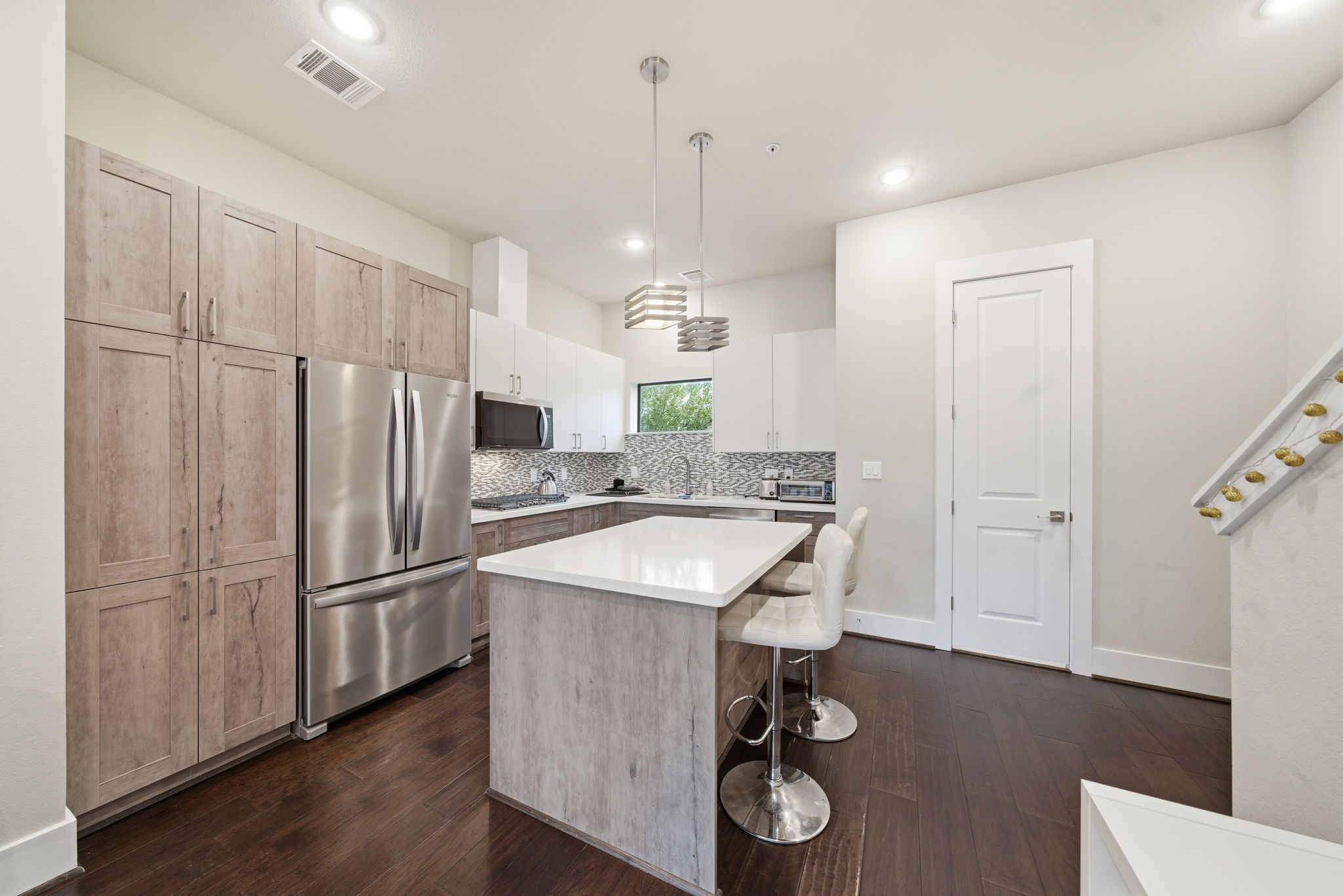 2401 Crawford Street, Unit C1C Houston, TX 77004 - Photo 10 of 24 a kitchen with stainless steel appliances granite countertop a sink refrigerator and microwave