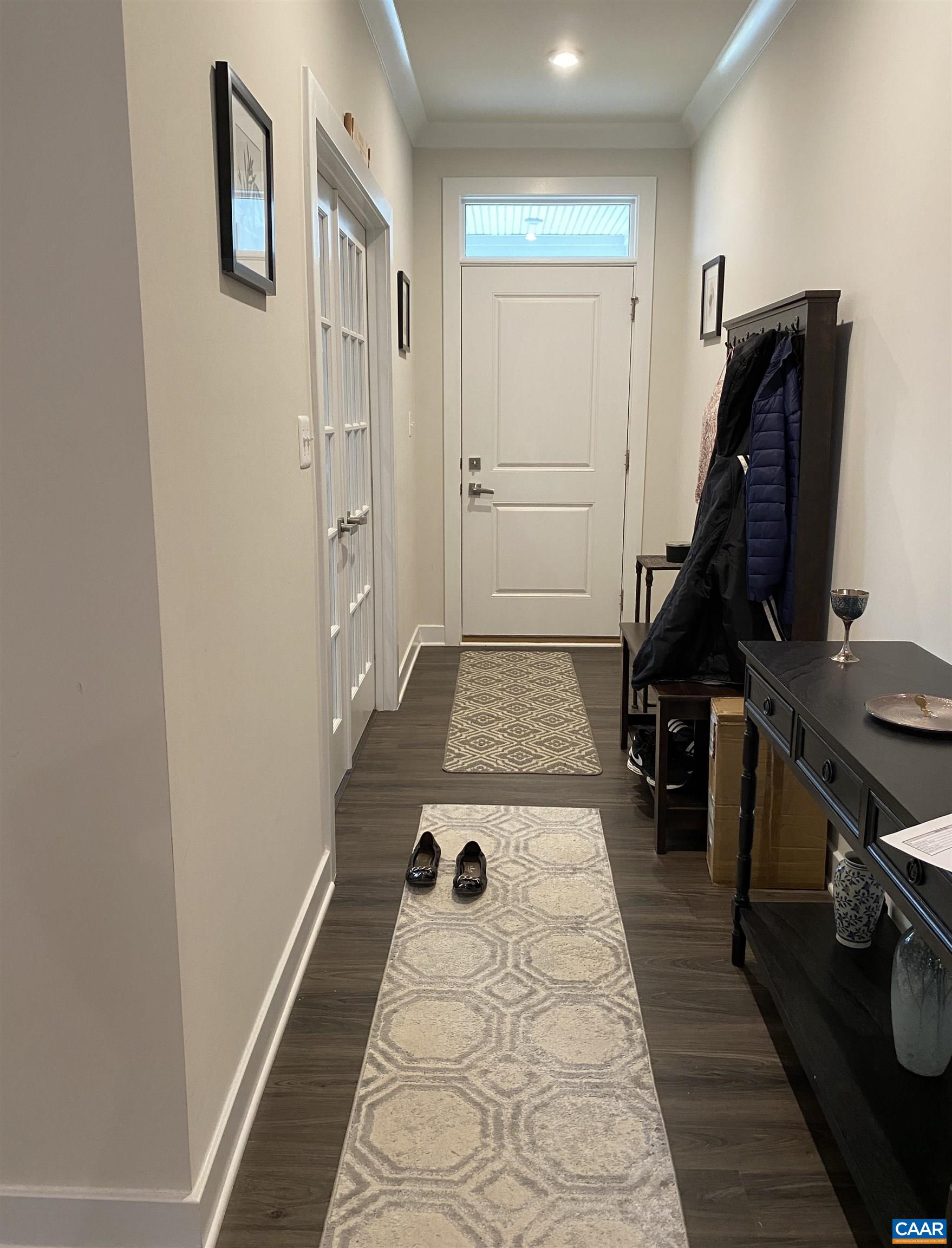 3402 Steamer Drive Keswick, VA 22947 - Photo 12 of 27 a view of a hallway with wooden floor and a sink