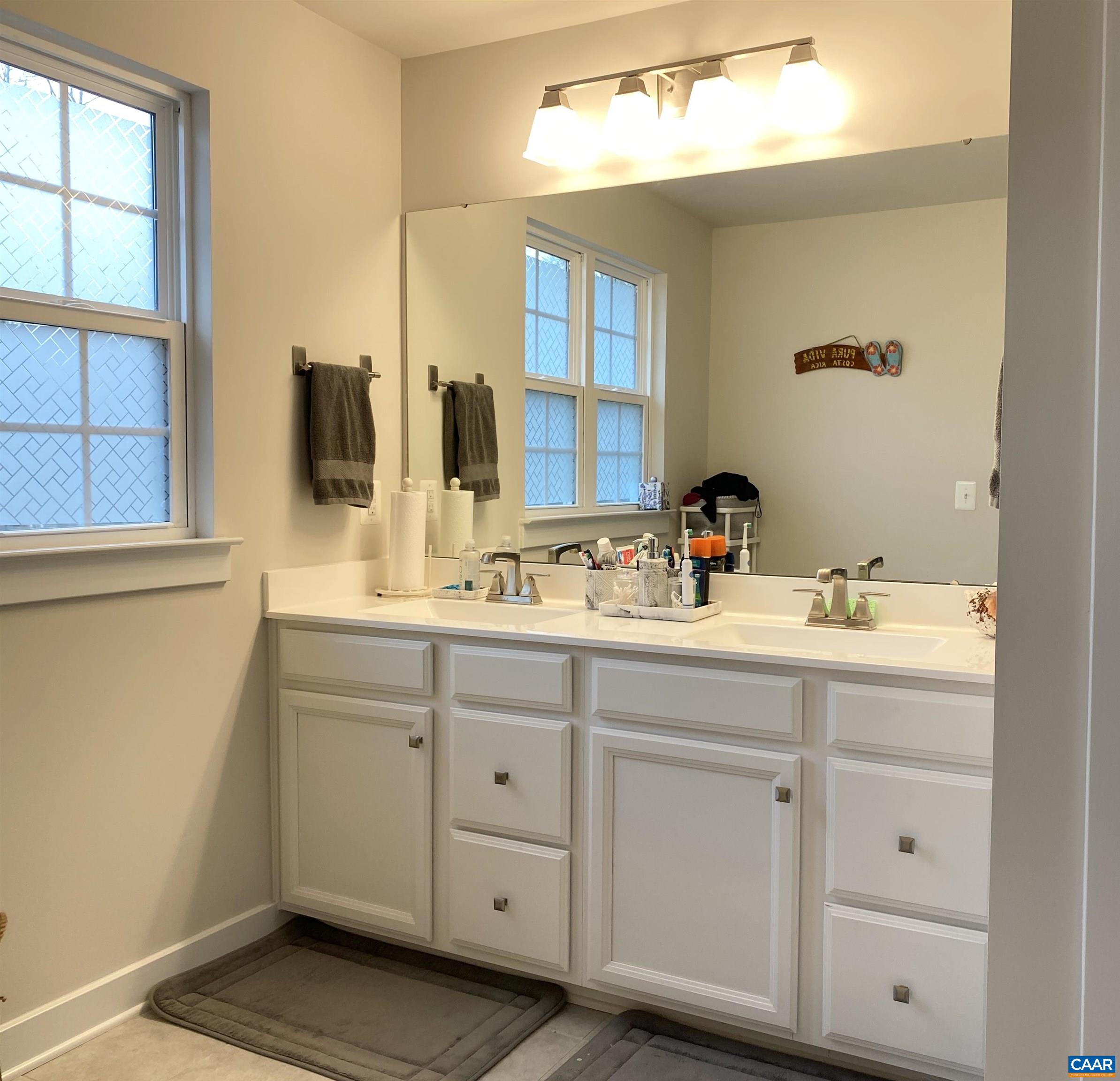 3402 Steamer Drive Keswick, VA 22947 - Photo 15 of 27 a bathroom with a sink vanity and mirror