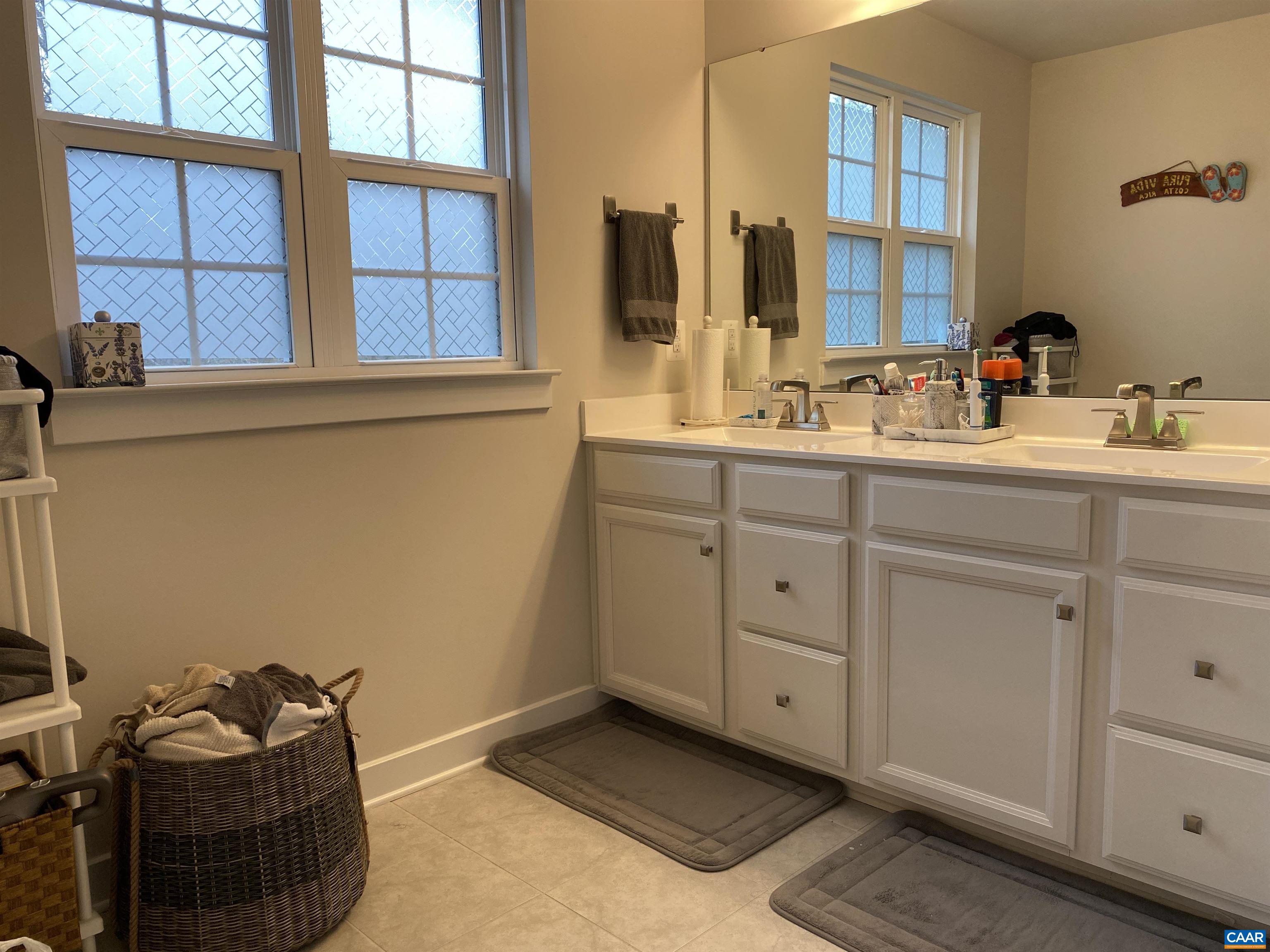 3402 Steamer Drive Keswick, VA 22947 - Photo 16 of 27 a bathroom with a sink and a mirror
