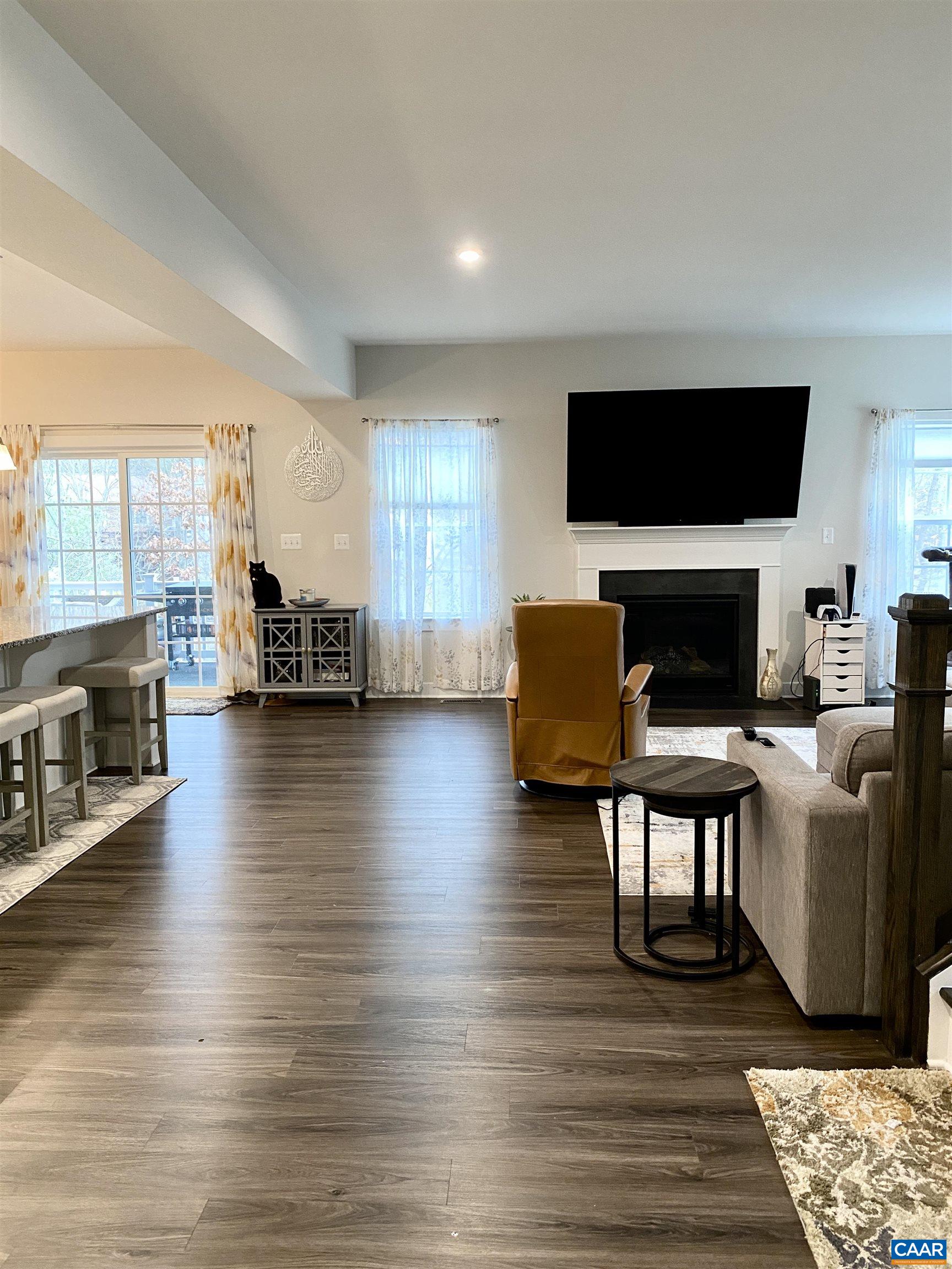 3402 Steamer Drive Keswick, VA 22947 - Photo 6 of 27 a living room with furniture a flat screen tv and a fireplace
