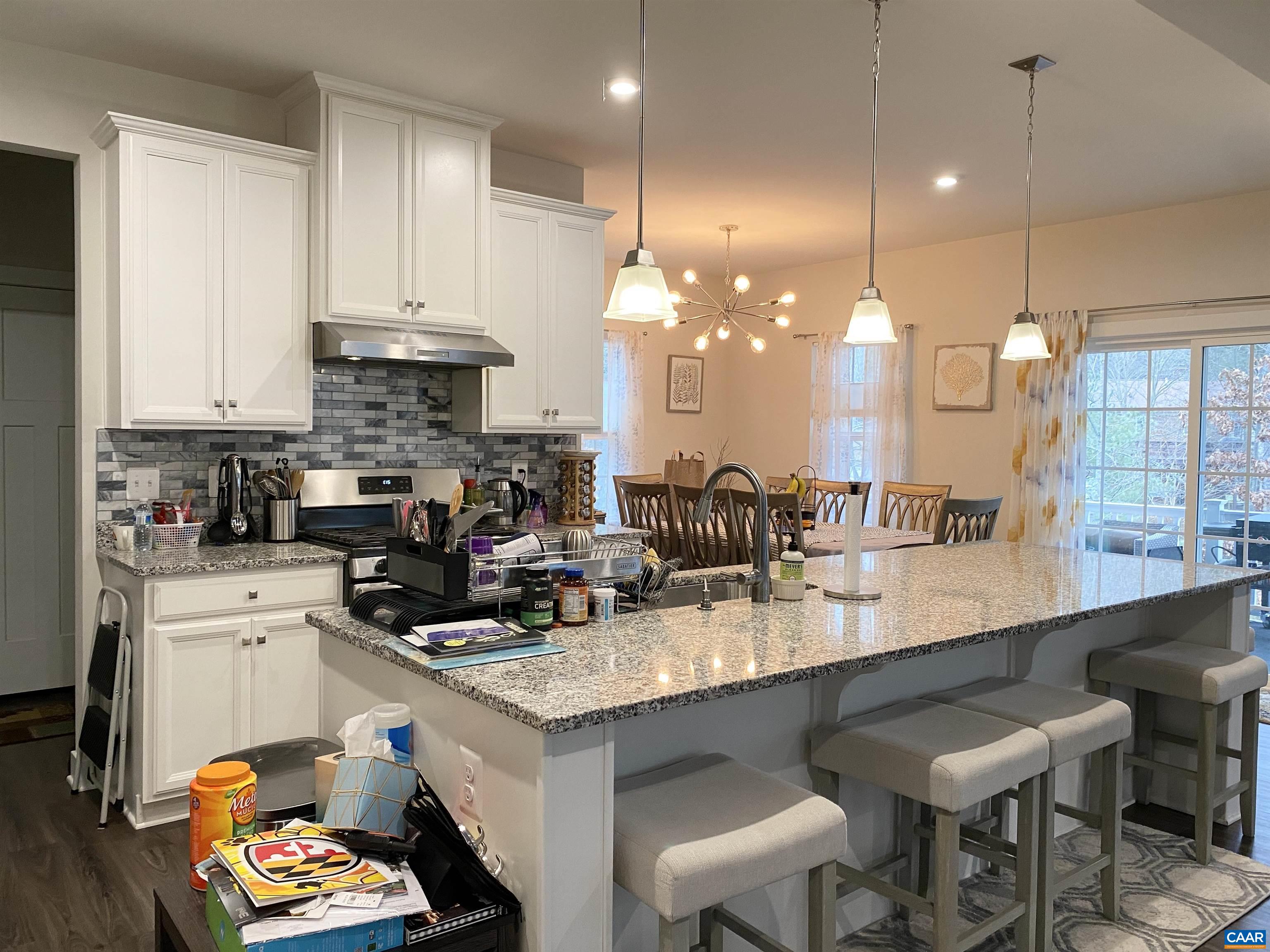 3402 Steamer Drive Keswick, VA 22947 - Photo 8 of 27 a kitchen with kitchen island granite countertop a sink a stove and a refrigerator
