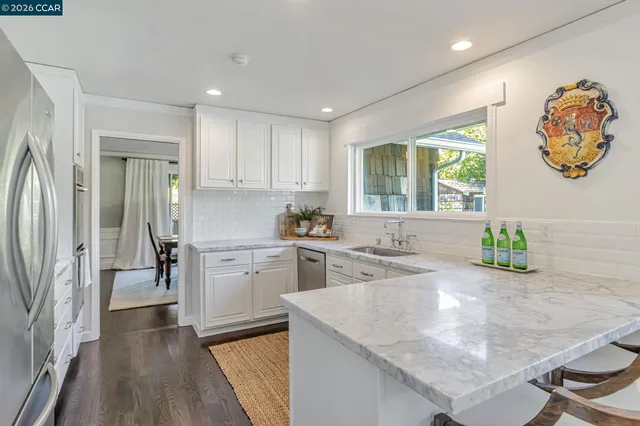 a kitchen with sink refrigerator and window