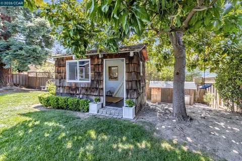 a view of a house with a backyard