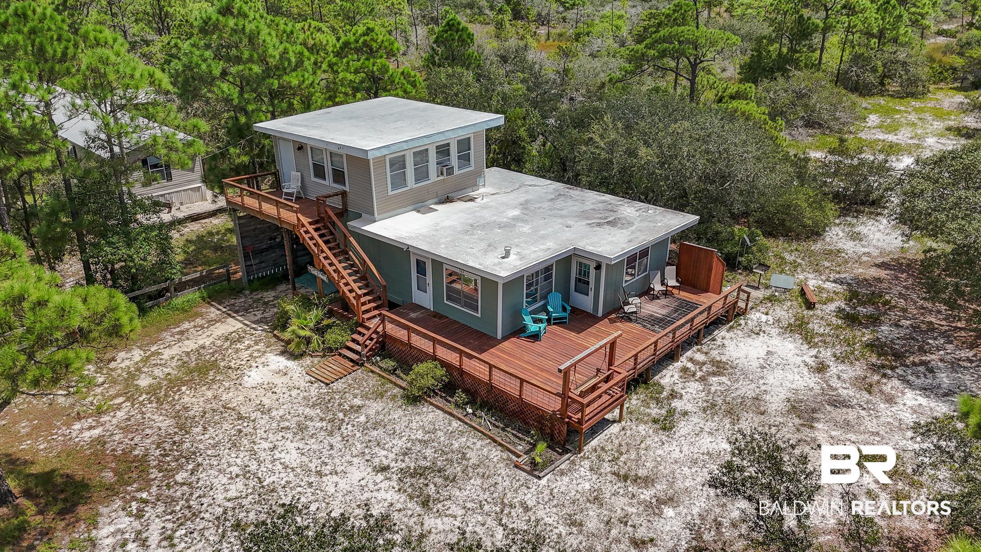 562 Veterans Road Gulf Shores, AL 36542 - Photo 3 of 32 Aerial view of property and surrounding area featuring a forest