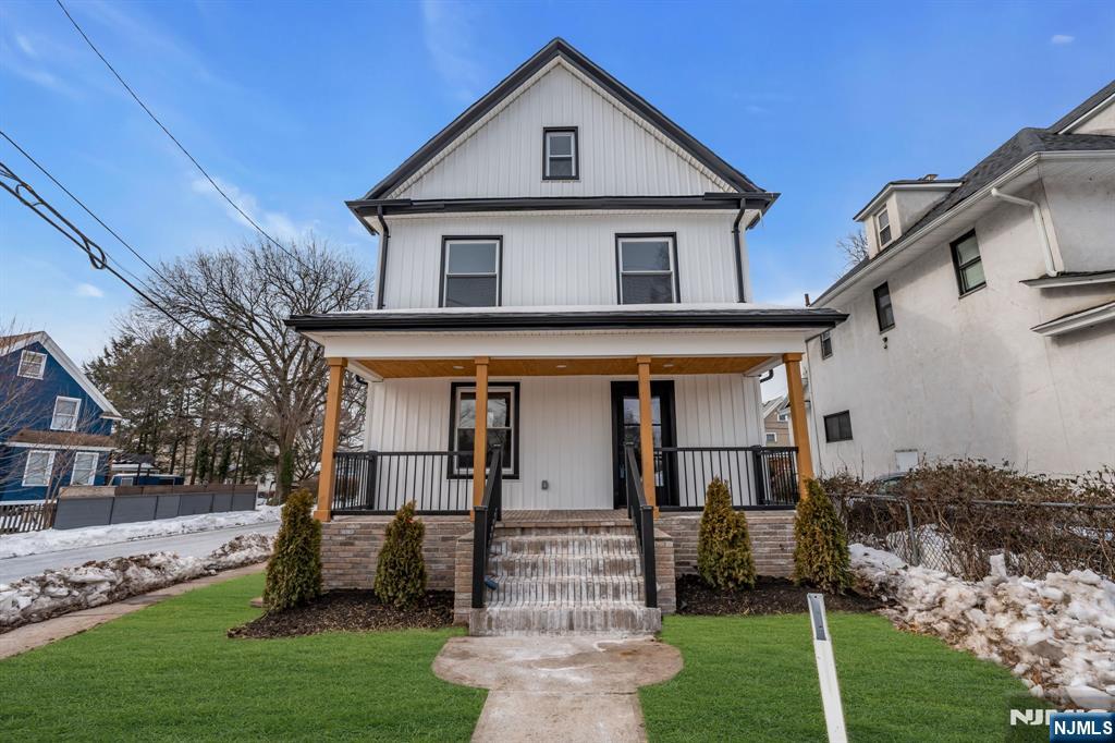 a front view of house with a garden