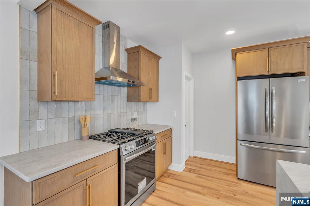 12 Enfield Avenue Montclair, NJ 07042 - Photo 19 of 50 a kitchen with stainless steel appliances granite countertop a refrigerator a stove and a sink with wooden floor