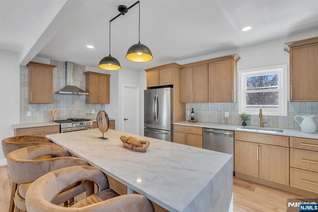 12 Enfield Avenue Montclair, NJ 07042 - Photo 23 of 50 a kitchen with stainless steel appliances granite countertop a sink a stove and refrigerator