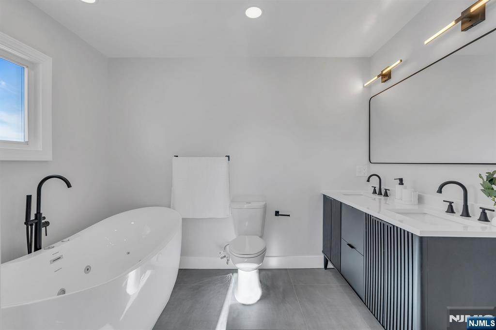 12 Enfield Avenue Montclair, NJ 07042 - Photo 28 of 50 a bathroom with a sink a toilet and mirror