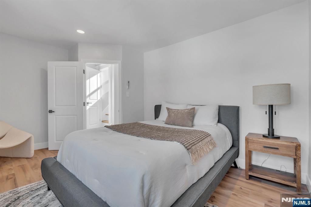 12 Enfield Avenue Montclair, NJ 07042 - Photo 30 of 50 a spacious bedroom with a bed and a lamp