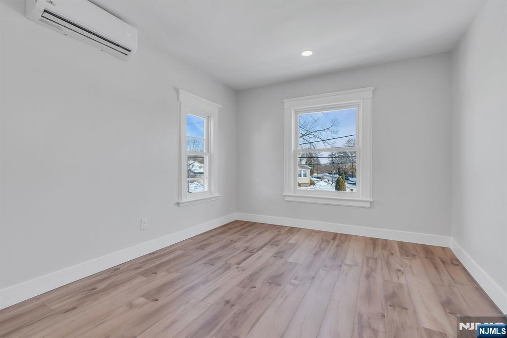 12 Enfield Avenue Montclair, NJ 07042 - Photo 33 of 50 an empty room with wooden floor and windows