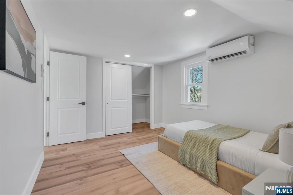 12 Enfield Avenue Montclair, NJ 07042 - Photo 41 of 50 a spacious bedroom with a bed and a window