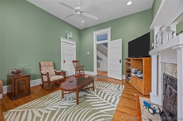 a living room with furniture and a chandelier