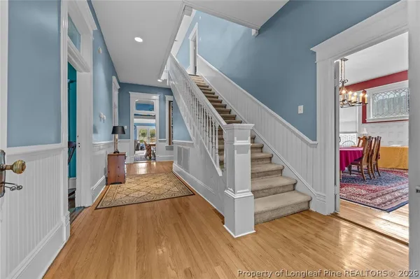 a view of entryway and hall with wooden floor