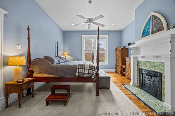 a bedroom with furniture and a fireplace