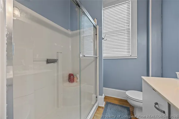 a white toilet sitting next to a bathroom sink