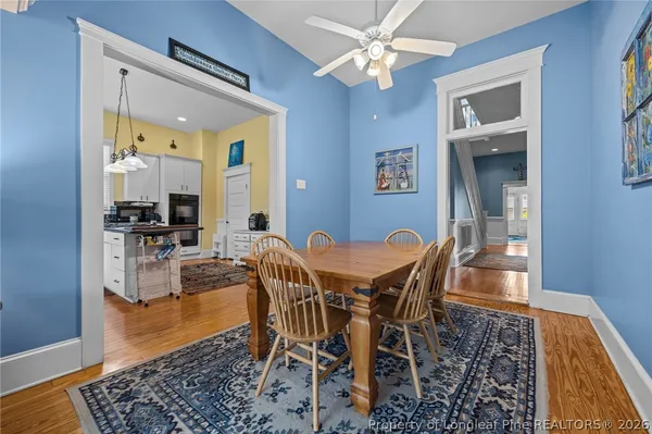 a view of a dining room with furniture and wooden floor