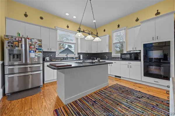 a kitchen with stainless steel appliances a stove a refrigerator and a sink