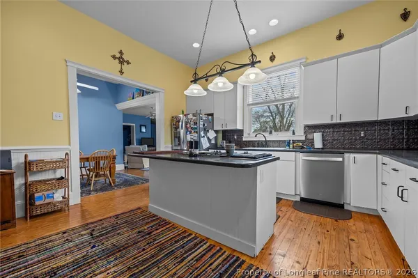 a kitchen with stove and cabinets