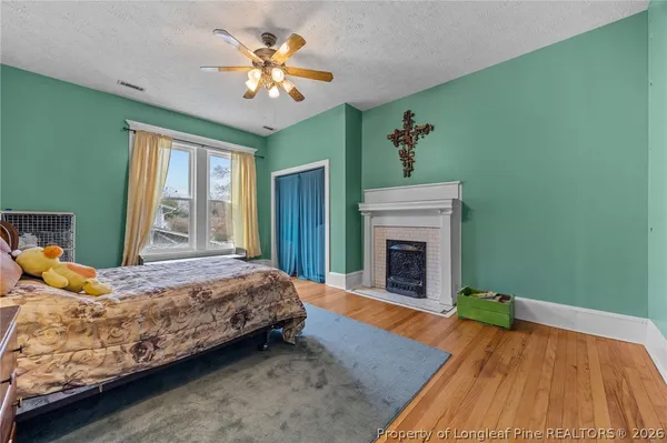 a bedroom with a bed and a fireplace