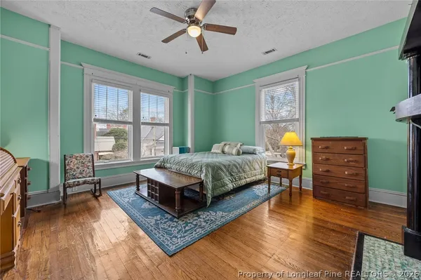 a bedroom with a bed dresser and a window