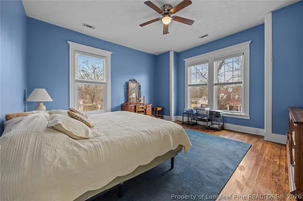 a bedroom with bed window and couch