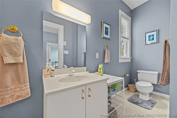 a bathroom with a sink toilet and mirror