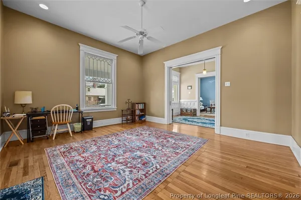 a bedroom with furniture and a rug