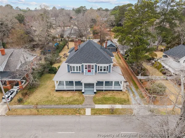 an aerial view of a house with a yard basket ball court and outdoor seating