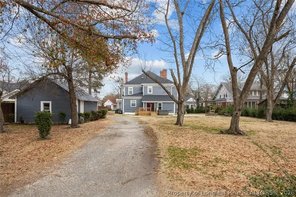a front view of a house with a yard covered in snow